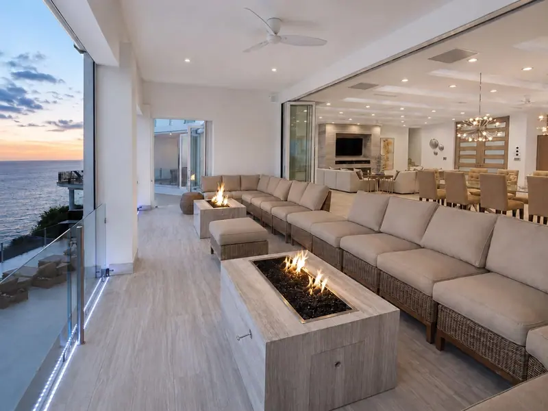Villa Lands End terrace at dusk with fire pits and dining